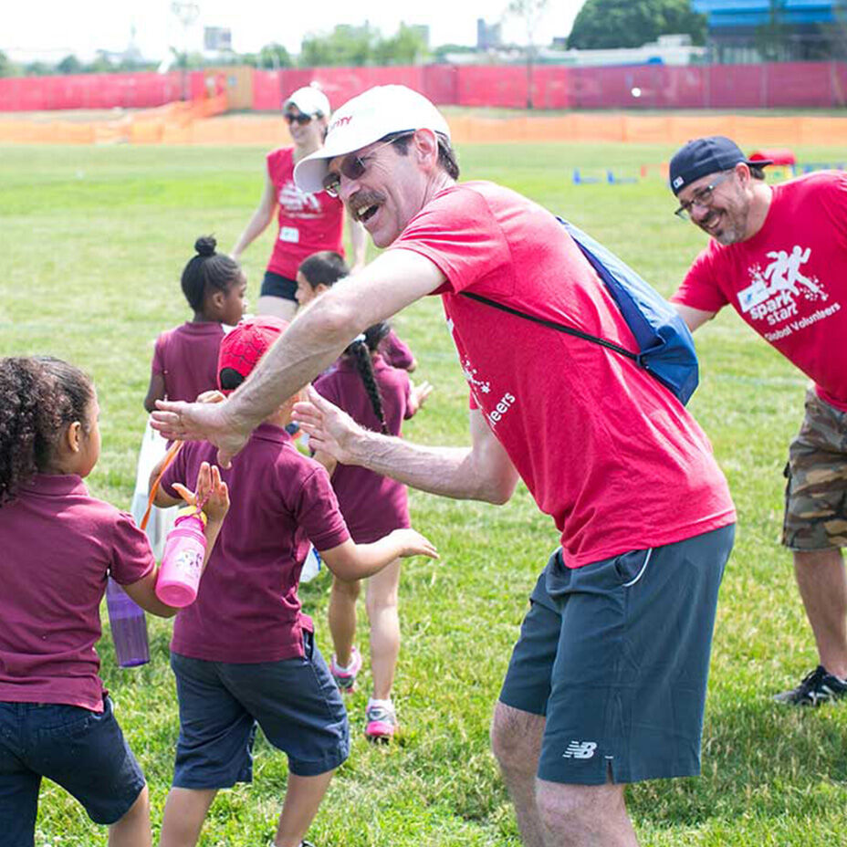 Employees participating in field day with kids