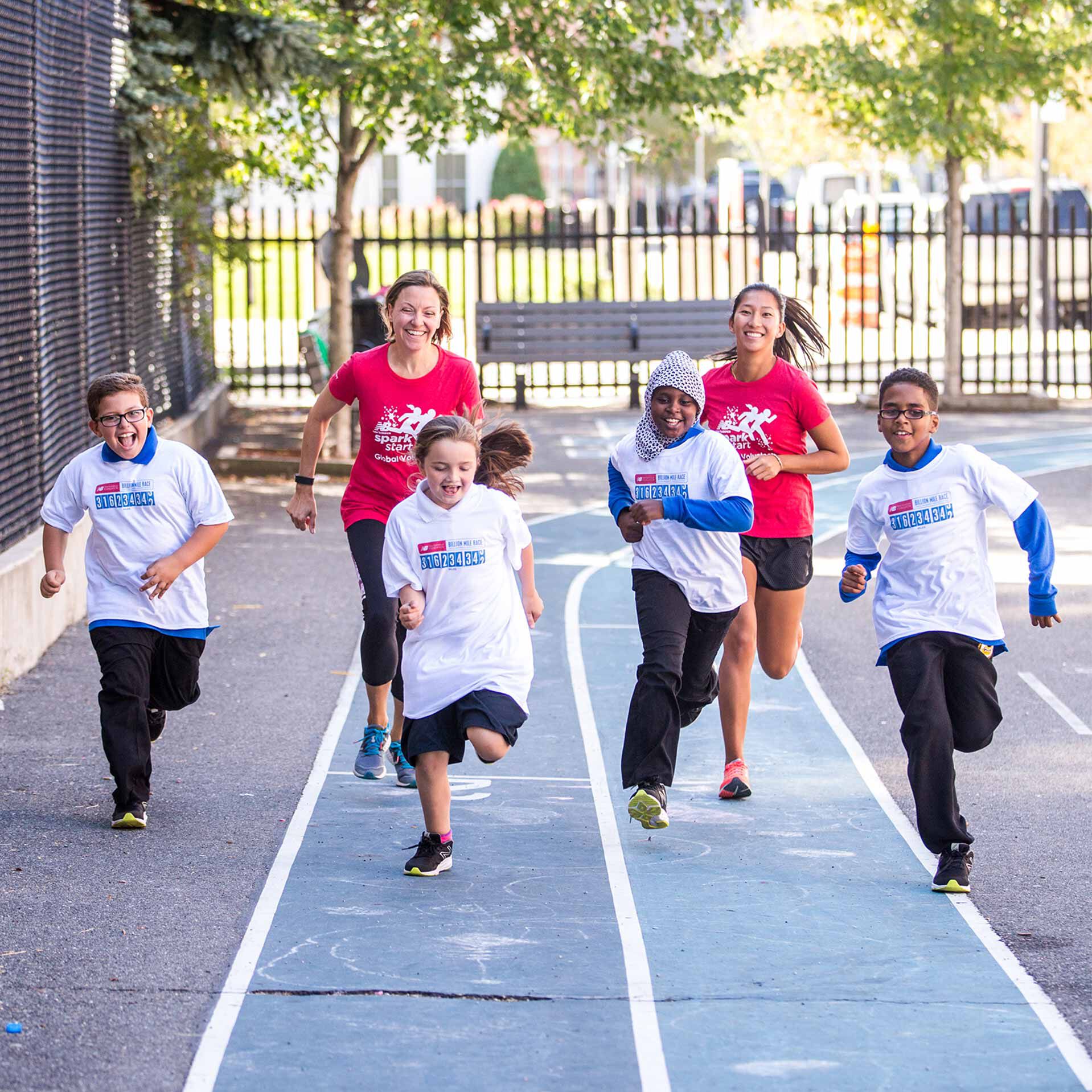 Kids and employees running on track